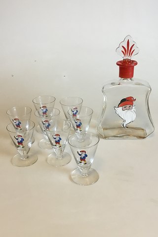 Christmas carafe with 8 small glasses. Decorated with Santa Claus. The Carafe is 
spherical grinded at the bottom and labeled "6". A glass with chip