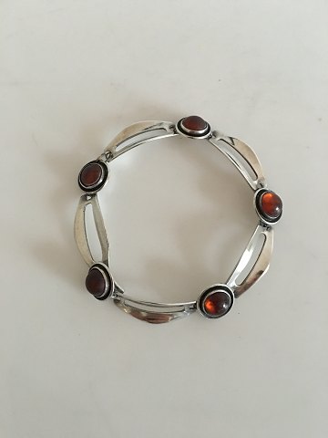 N. E. From bracelet made by sterling silver with amber.