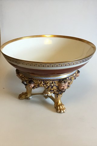 Bing og Grondahl Punch Bowl on stand of porcelain, decorated in red, blue and 
gold. Stand with modeled leaves, faun and buck heads, standing on three animal 
paws style of Heinrich Hansen