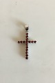 Pendant in 18 K. White gold shaped like cross with 16 red stones